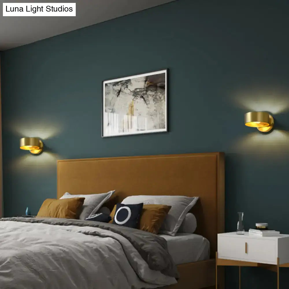 Pair of brass curved wall lamps by Decorbites; gold sconces flank bed on teal wall on Tampa Home & Garden Store