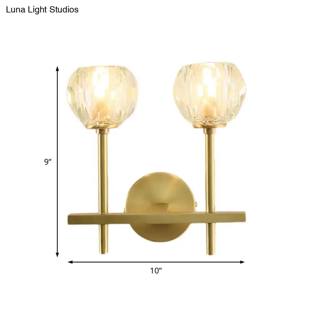 Brass crystal wall sconce with twin glass globe shades in gold finish on Tampa Home & Garden Store