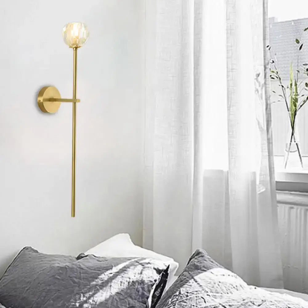 Decorbites brass crystal wall sconce with slender stem and faceted globe shade on wall on Tampa Home & Garden Store