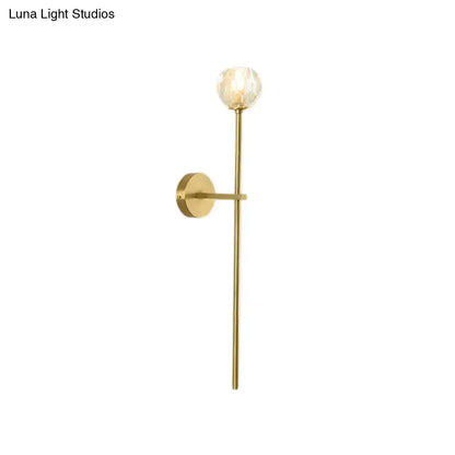 Brass crystal wall sconce by Decorbites with long vertical stem and faceted glass orb on Tampa Home & Garden Store