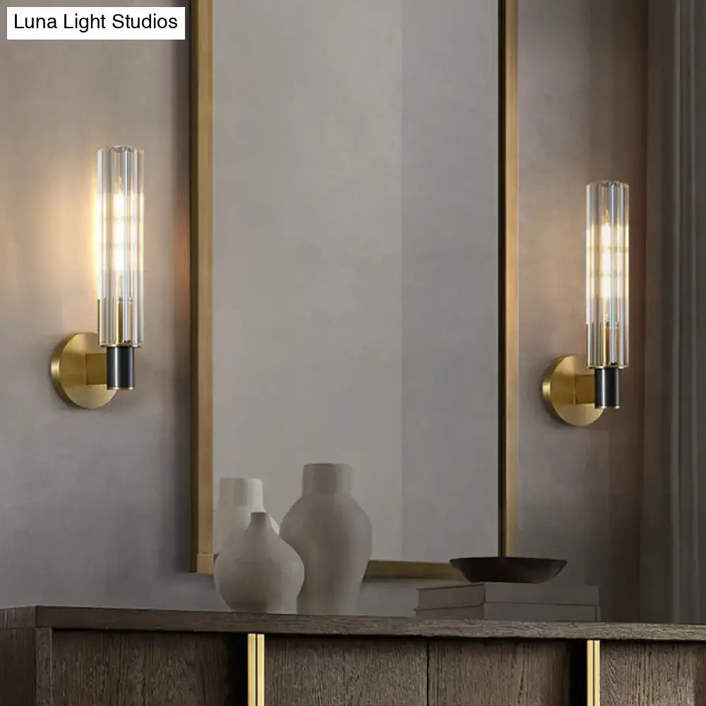Brass tubular wall sconces pair with glass cylinder shades and black socket details by Decorbites on Tampa Home & Garden Store