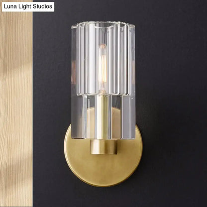 Brass ribbed glass sconce by Decorbites with clear shade and brass backplate on Tampa Home & Garden Store