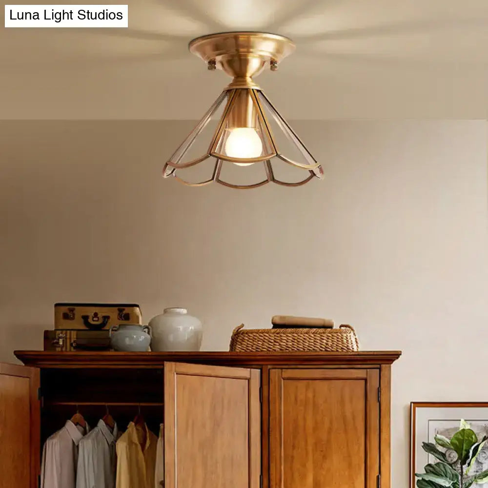 Brass scalloped flush mount ceiling light with a cage-style frame and glass shade on Tampa Home & Garden Store