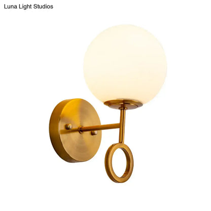 Brass Cream Glass Sconce with frosted globe shade, wall-mounted brass arm and ring Decorbites on Tampa Home & Garden Store