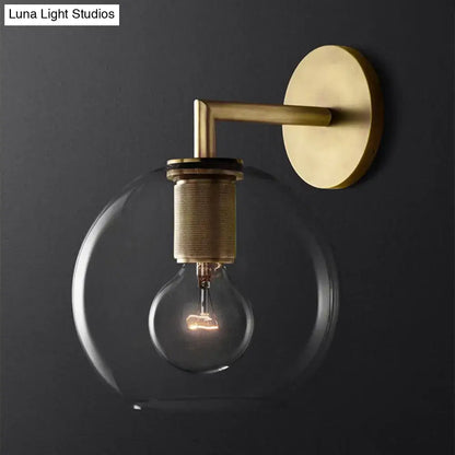 Bronze glass wall sconce with brass mount and clear globe bulb by Decorbites on Tampa Home & Garden Store