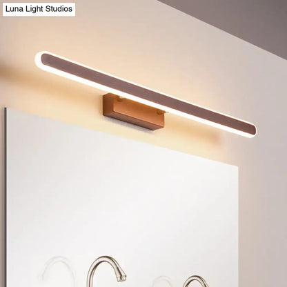 Decorbites brown LED vanity sconce; long rounded LED bar with wood mount above bathroom mirror on Tampa Home & Garden Store