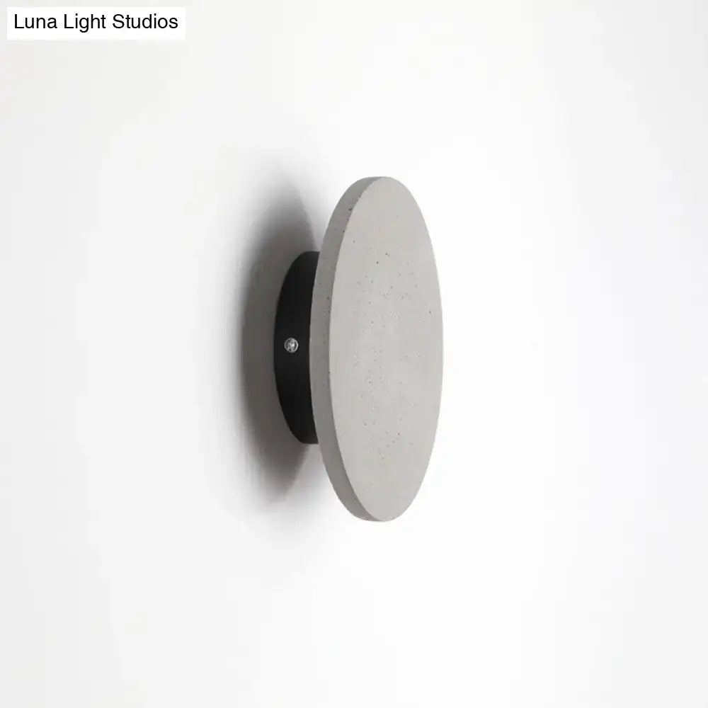 Grey cement round wall sconce with black mounting plate by Decorbites on Tampa Home & Garden Store