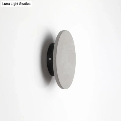 Grey cement round wall sconce with black mounting plate by Decorbites on Tampa Home & Garden Store