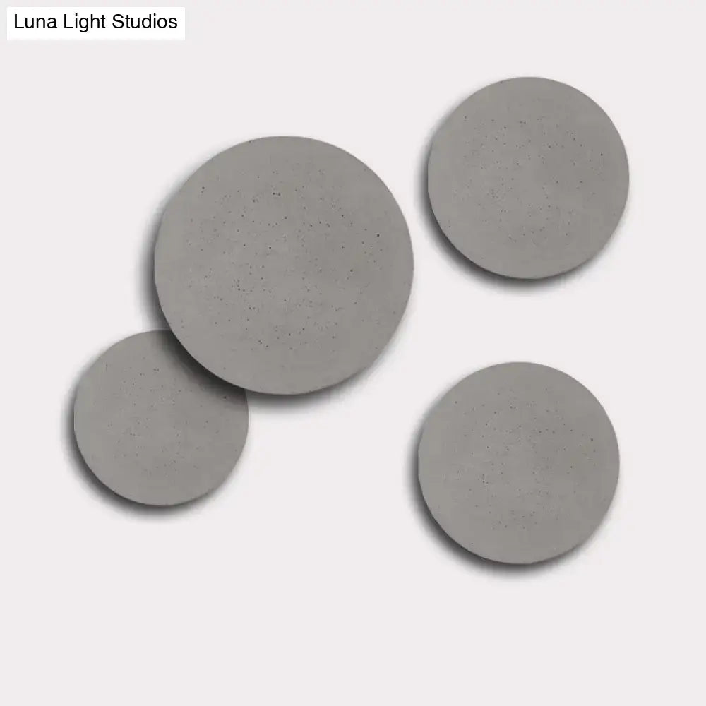 Grey cement wall sconce by Decorbites featuring four round discs in varying sizes on Tampa Home & Garden Store