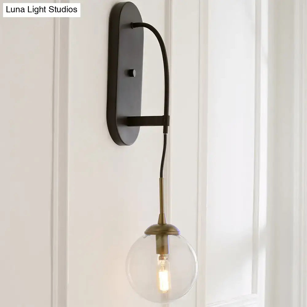 Black Glass Wall Sconce Decorbites with industrial brass accents and clear glass globe on Tampa Home & Garden Store