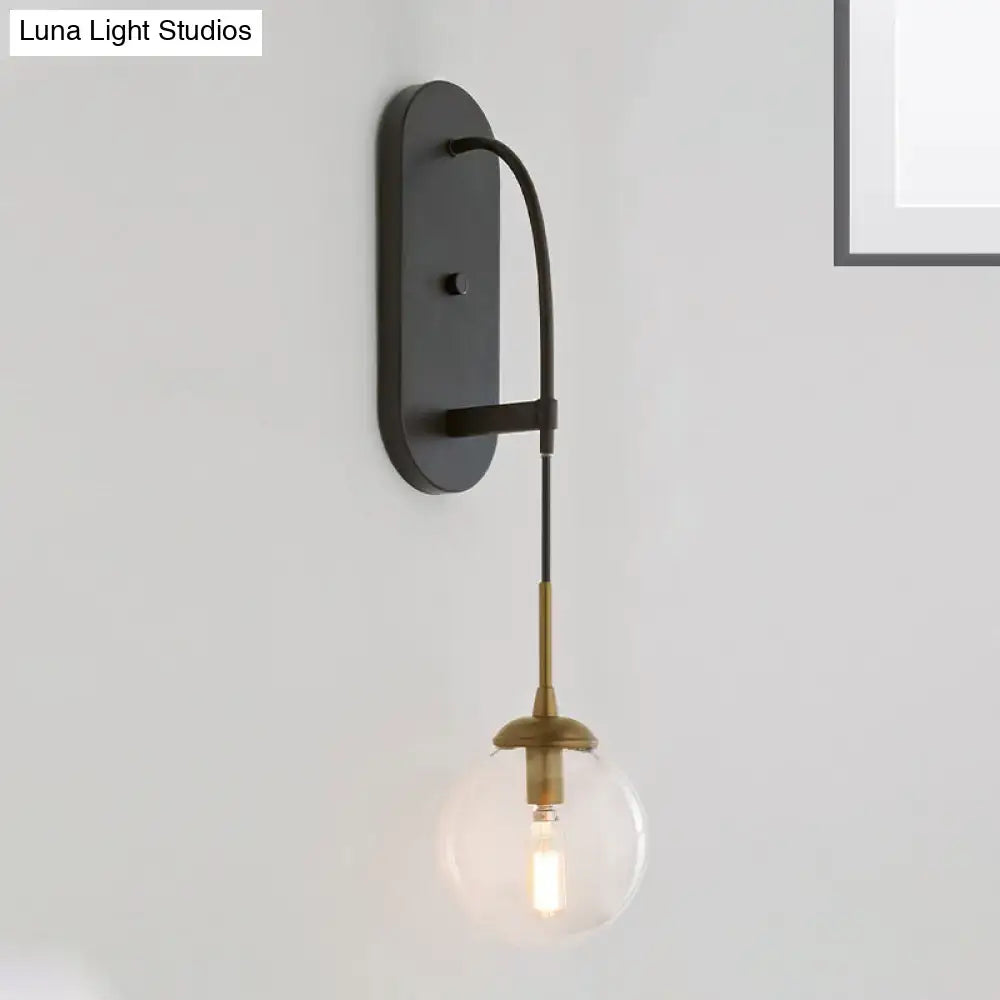 Black glass wall sconce with brass hardware and Edison bulb industrial style on Tampa Home & Garden Store