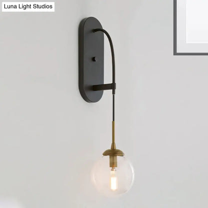 Black glass wall sconce with brass hardware and Edison bulb industrial style on Tampa Home & Garden Store