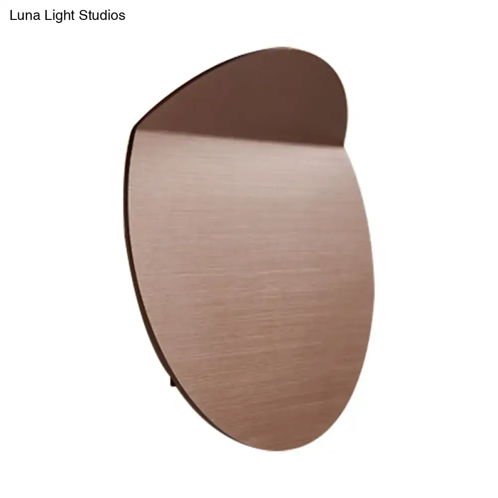 Copper wall sconce light with round brushed copper disc silhouette on Tampa Home & Garden Store