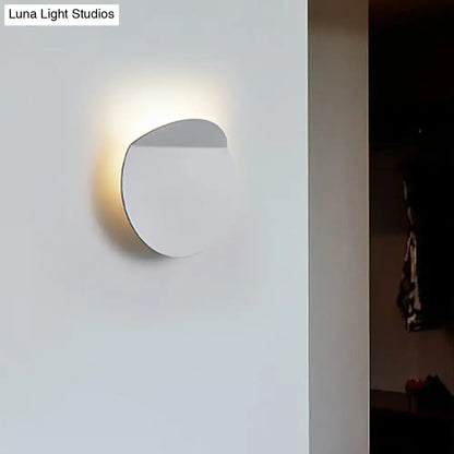 Copper wall sconce light with round disc design and warm glow on Tampa Home & Garden Store