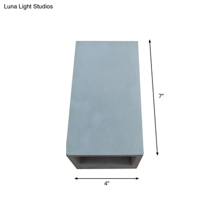 Grey cement wall light sconce with open-bottom design, 7in tall by 4in wide on Tampa Home & Garden Store