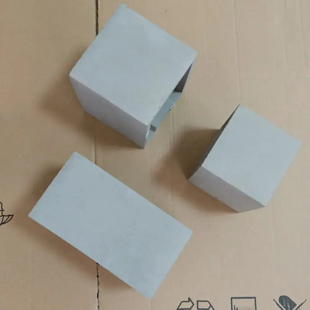 Grey cement wall light by Decorbites, three square cement blocks on cardboard on Tampa Home & Garden Store