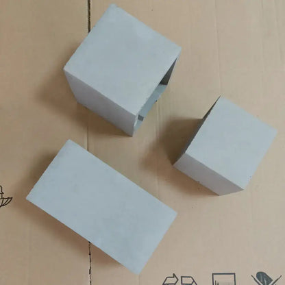 Grey cement wall light by Decorbites, three square cement blocks on cardboard on Tampa Home & Garden Store