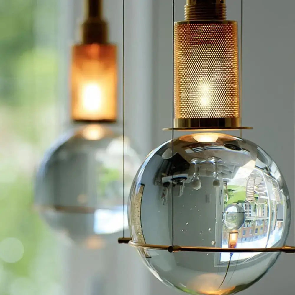 Brass crystal globe pendant light with reflective glass sphere and brass shade on Tampa Home & Garden Store
