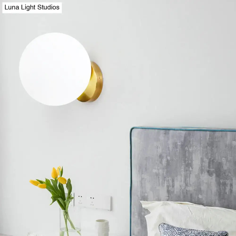 Gold brass wall sconce with frosted white glass globe LED bulb by Decorbites on Tampa Home & Garden Store