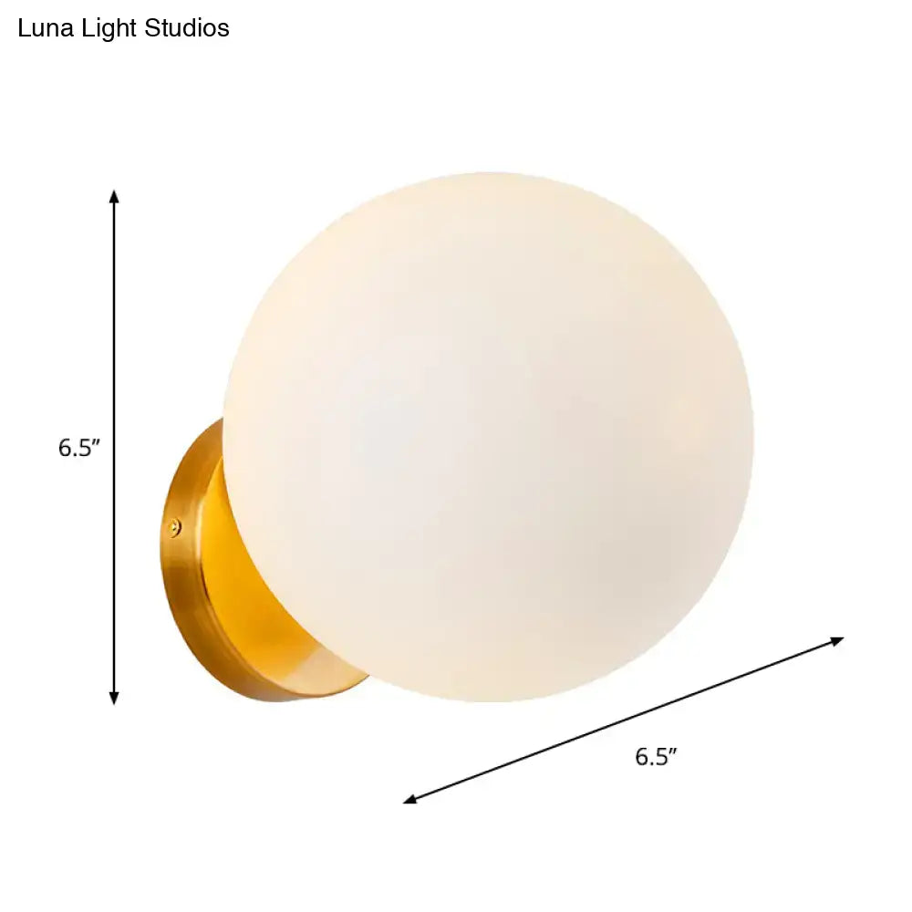 Gold finish wall sconce with frosted white glass globe and LED bulb by Decorbites on Tampa Home & Garden Store