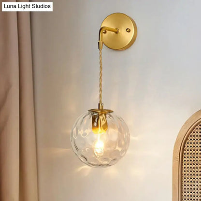 Gold hammered glass sconce by Decorbites with round glass shade and fabric cord on Tampa Home & Garden Store