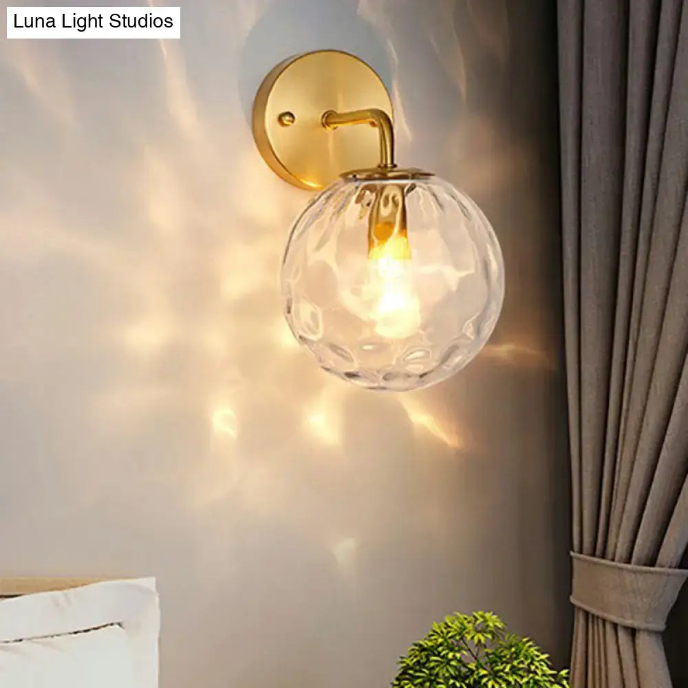 Gold hammered glass sconce with round clear globe and brass backplate by Decorbites on Tampa Home & Garden Store