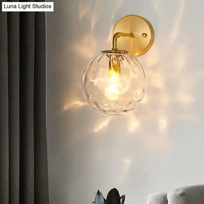 Gold hammered glass sconce with clear glass orb shade and brass wall mount by Decorbites on Tampa Home & Garden Store