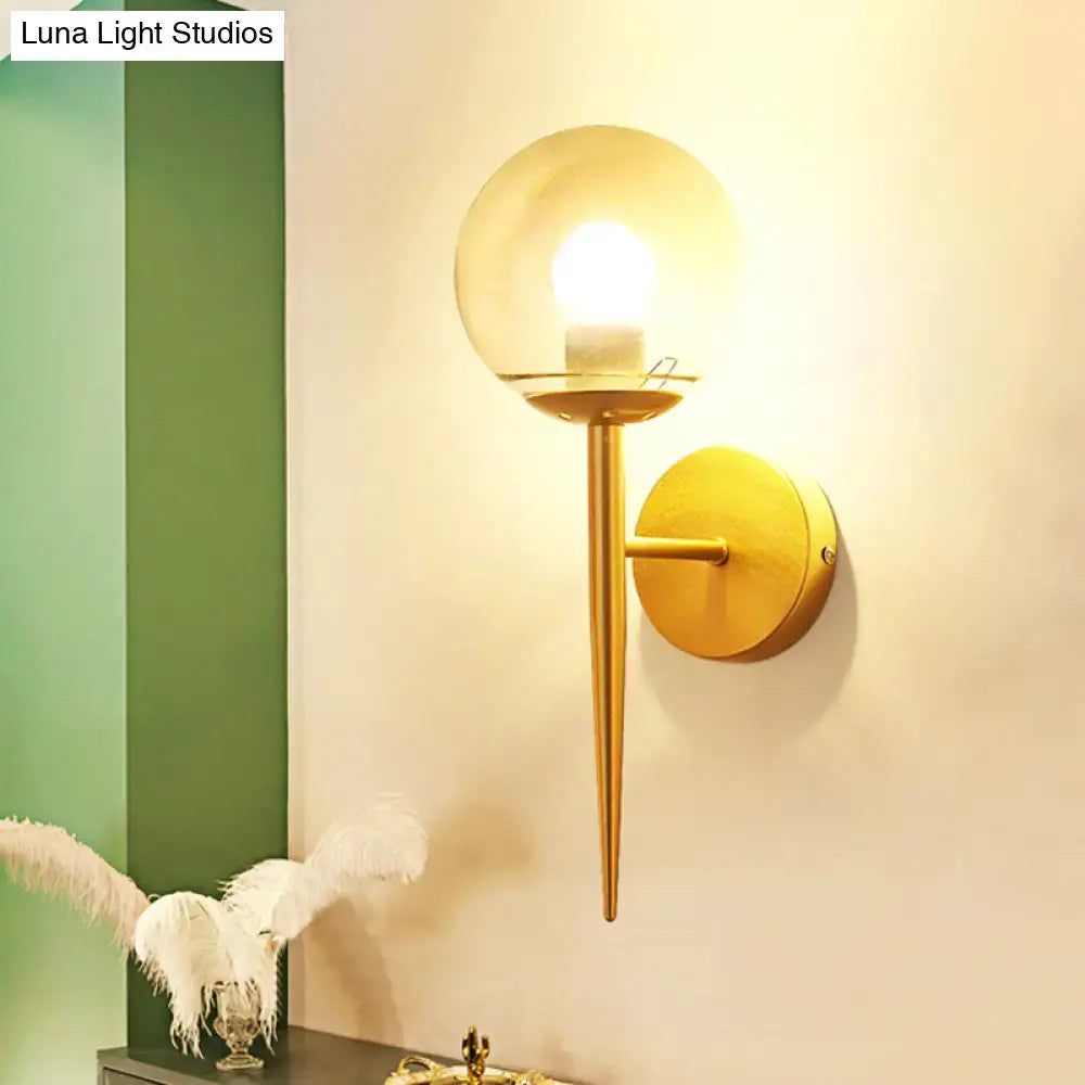 Decorbites gold glass wall sconce with clear globe shade and tapered arm on Tampa Home & Garden Store