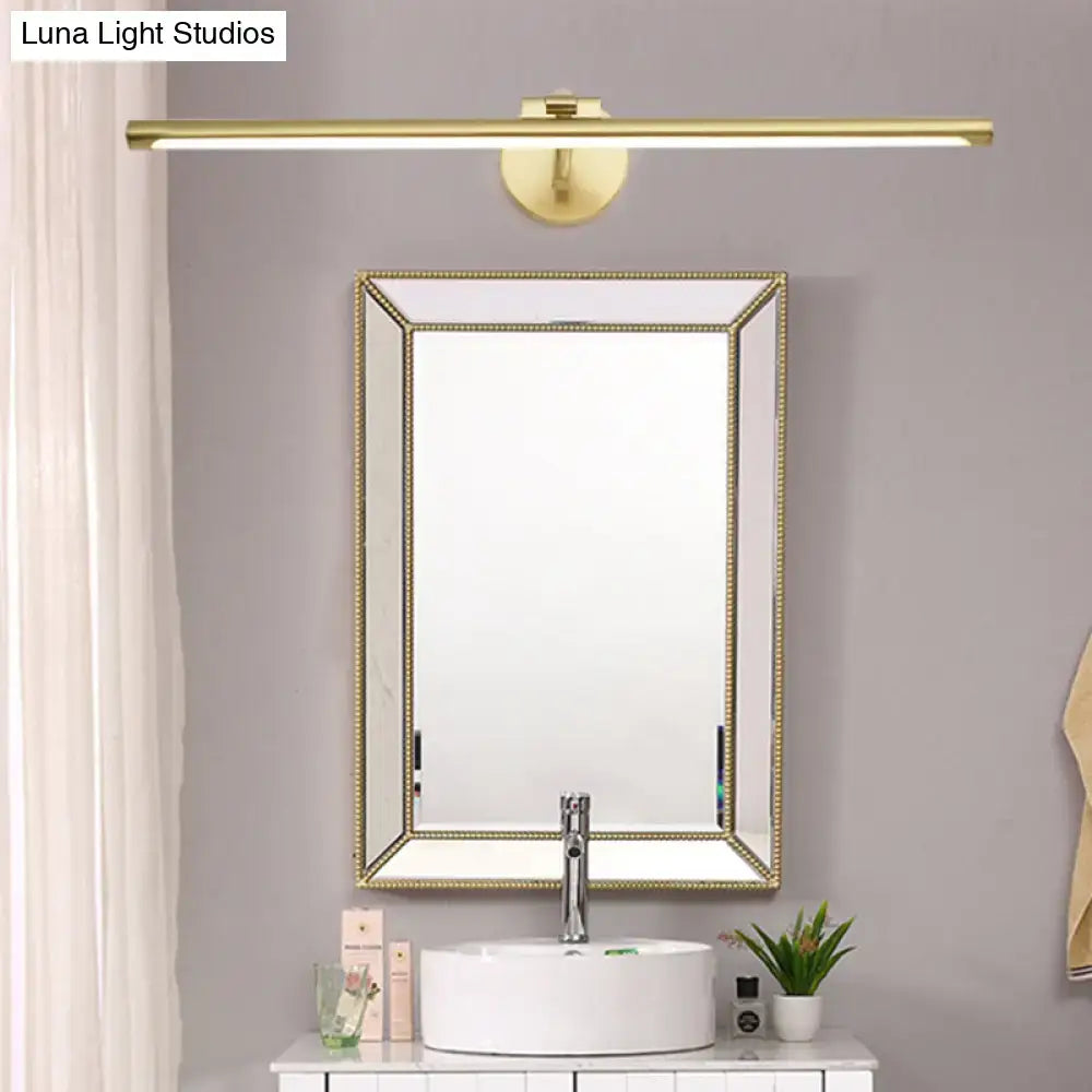 Brass LED vanity sconce by Decorbites above a framed beaded mirror and white sink on Tampa Home & Garden Store