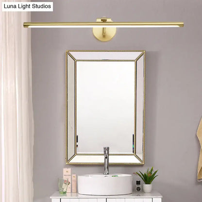 Brass LED vanity sconce by Decorbites above a framed beaded mirror and white sink on Tampa Home & Garden Store