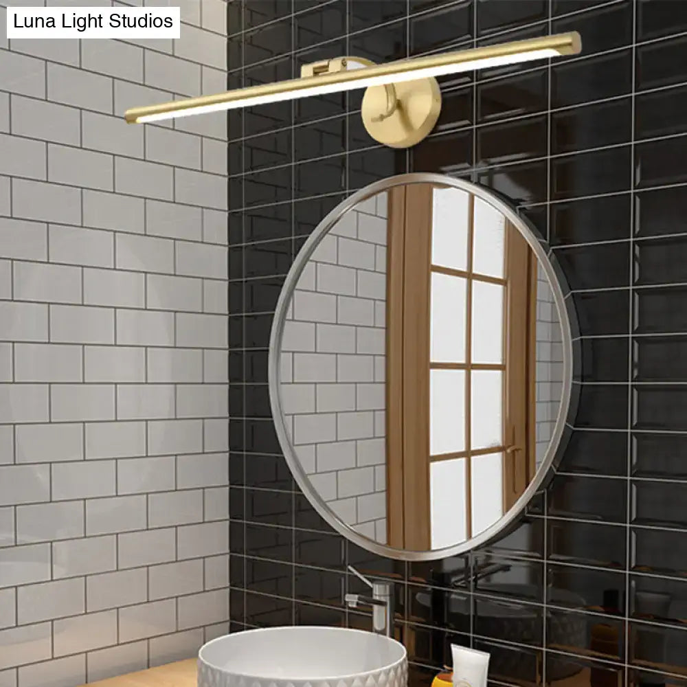 Brass LED vanity sconce with a horizontal bar above a round mirror in a black tile bathroom on Tampa Home & Garden Store