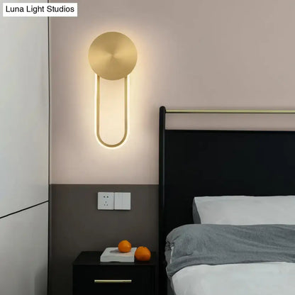 Gold Elliptical Wall Sconce by Decorbites, warm LED fixture on bedroom wall on Tampa Home & Garden Store