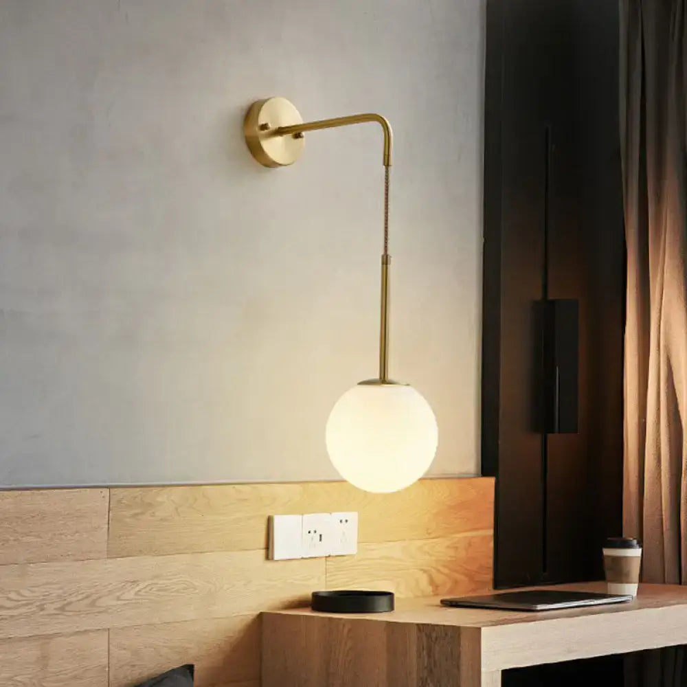 Decorbites gold cream glass sconce with curved brass arm and frosted globe, wall mounted on Tampa Home & Garden Store