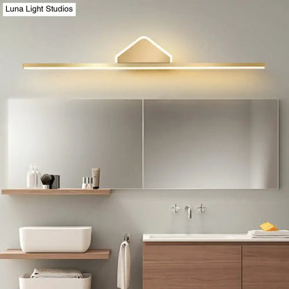 Gold-tone LED Linear Semicircle Vanity Light above a modern mirror with warm glow on Tampa Home & Garden Store