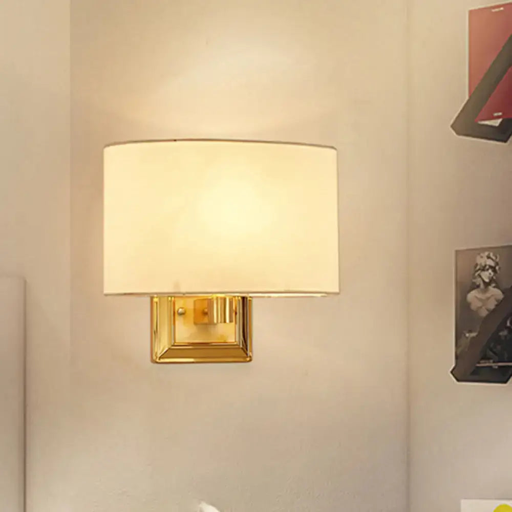 Gold rectangular fabric sconce with brass backplate and white shade on Tampa Home & Garden Store
