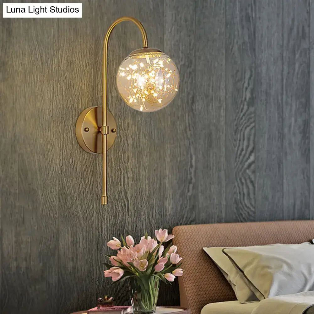 Gold gooseneck wall light by Decorbites with glass globe and brass backplate on Tampa Home & Garden Store