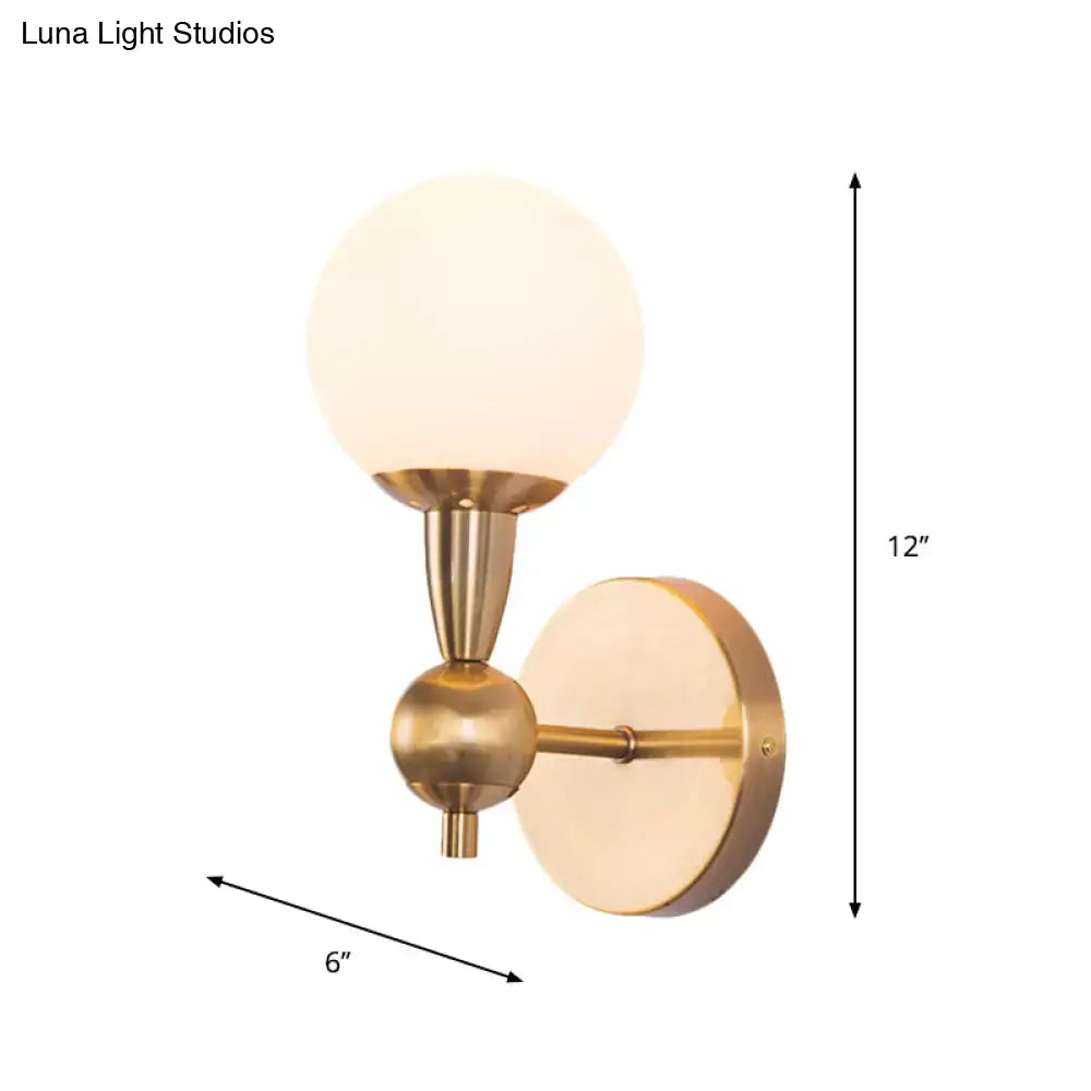 Gold hand blown sconce by Decorbites, brass finish with frosted glass globe, 12in height on Tampa Home & Garden Store