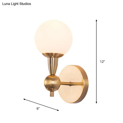 Gold hand blown sconce by Decorbites, brass finish with frosted glass globe, 12in height on Tampa Home & Garden Store
