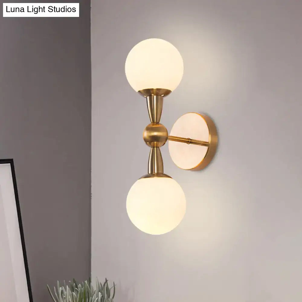 Gold hand-blown glass globe wall sconce with brass finish and twin frosted globes Decorbites on Tampa Home & Garden Store