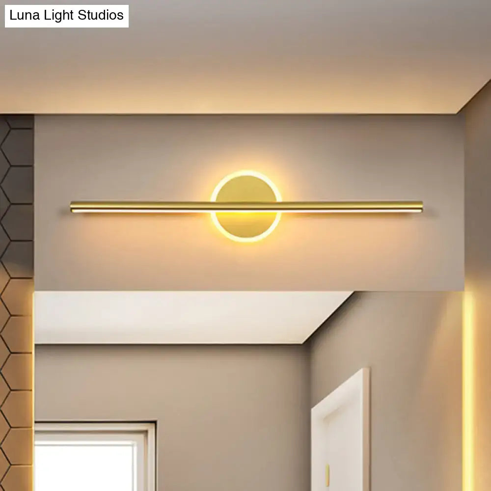 Decorbites gold linear 31-inch wall sconce with circular backplate and warm glow on Tampa Home & Garden Store