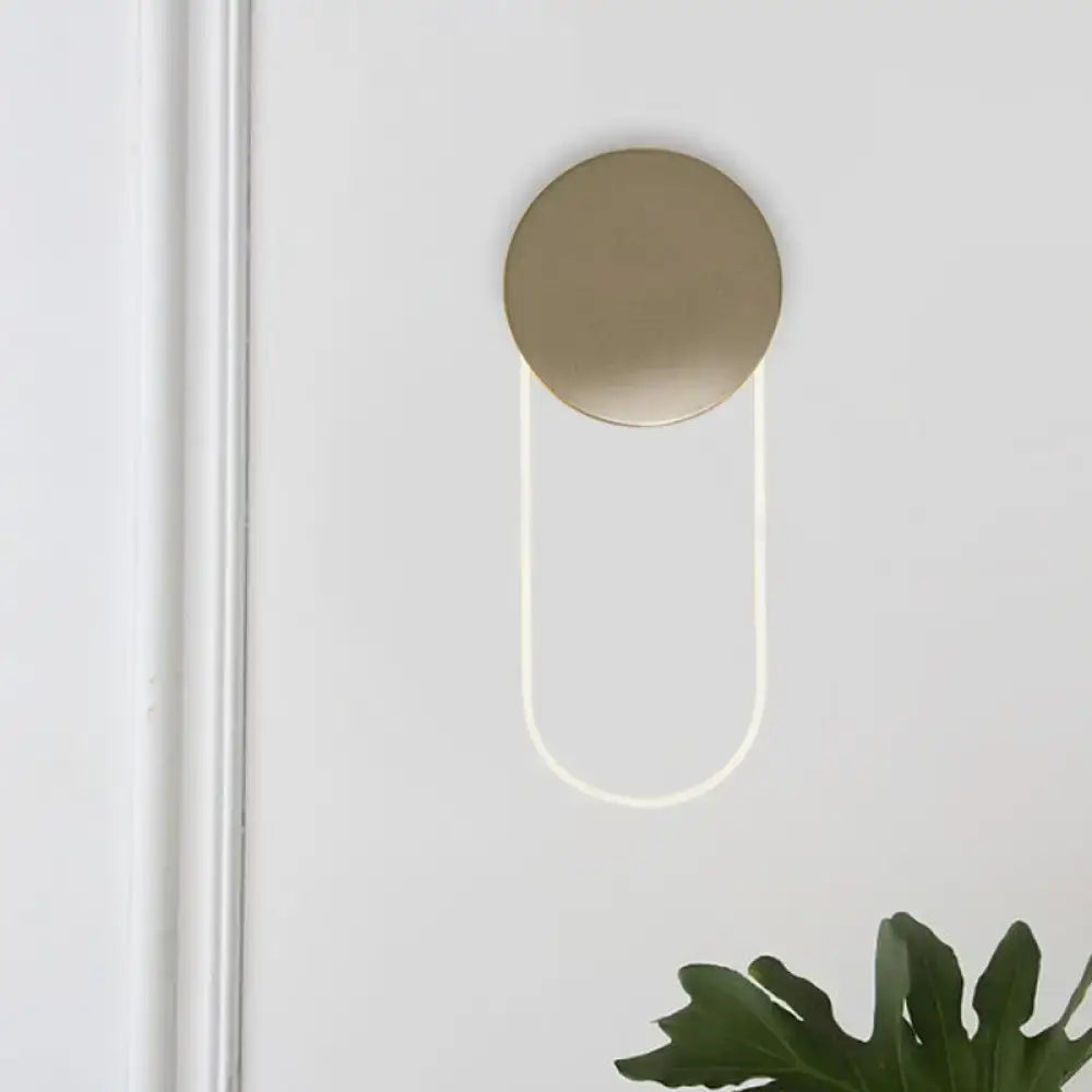 Gold oval LED wall lamp by Decorbites with a round backplate and U-shaped glow on Tampa Home & Garden Store
