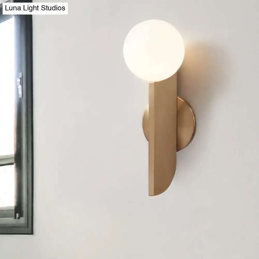 Decorbites gold metal mini globe sconce with round white glass globe on wall on Tampa Home & Garden Store