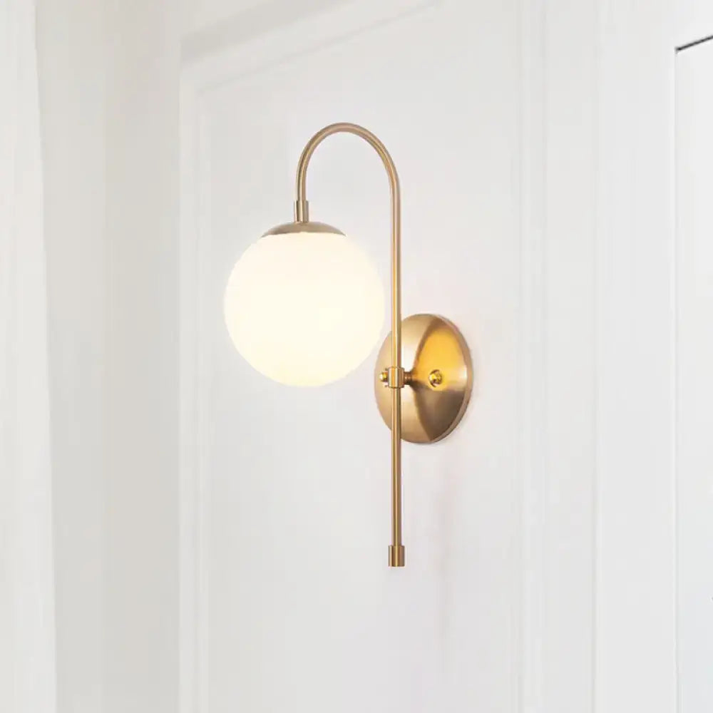 Decorbites gold mini globe sconce with curved brass arm and white glass shade wall light on Tampa Home & Garden Store