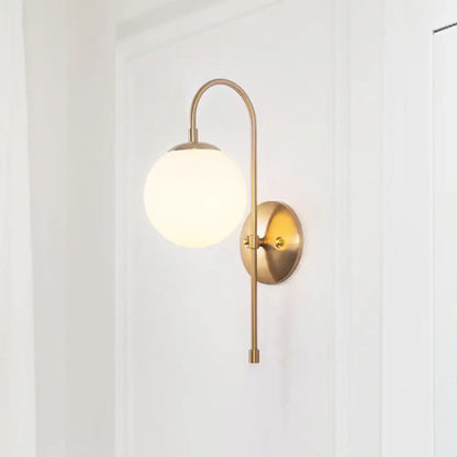 Decorbites gold mini globe sconce with curved brass arm and white glass shade wall light on Tampa Home & Garden Store