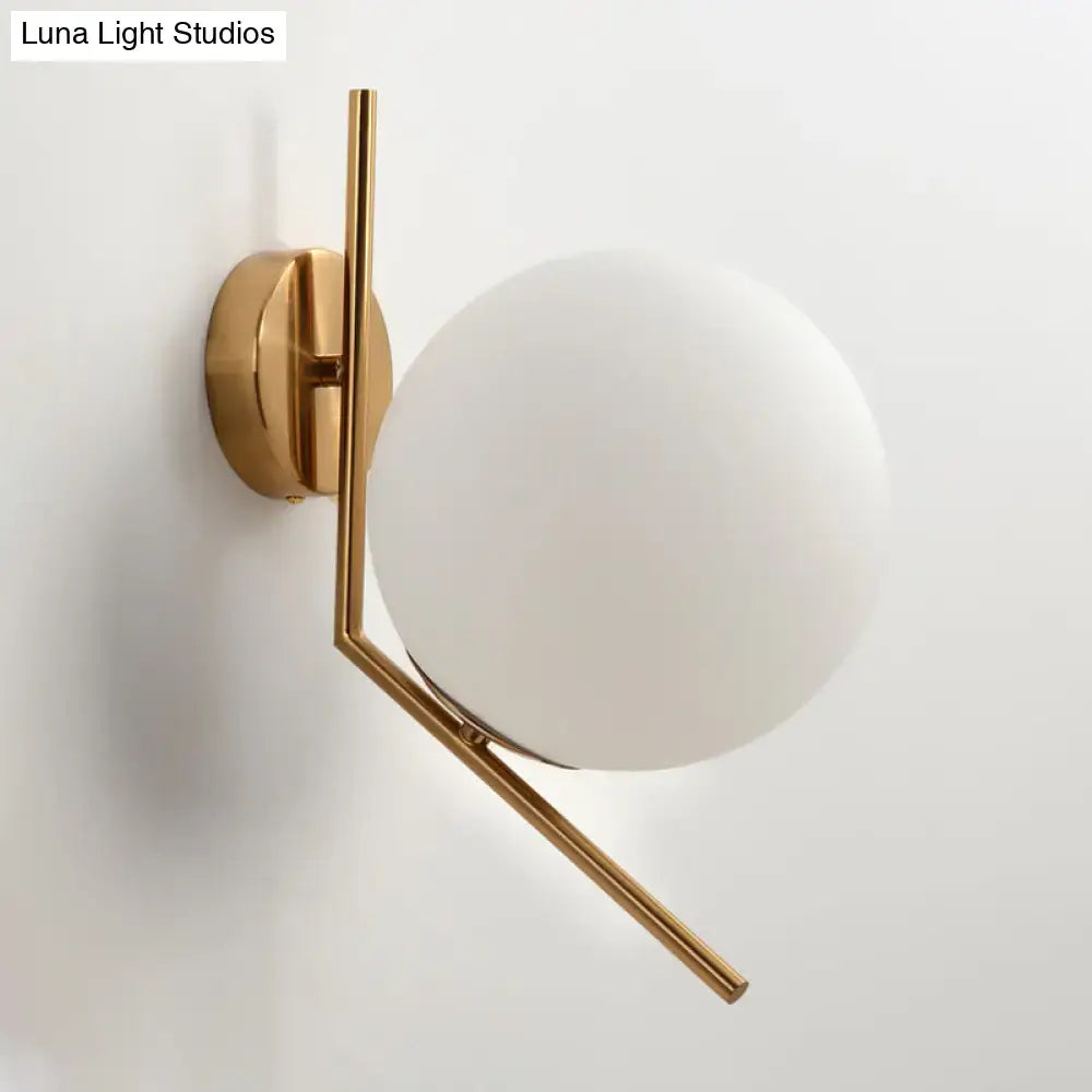Gold Mini Globe Sconce by Decorbites with brass frame and white frosted glass globe on wall on Tampa Home & Garden Store