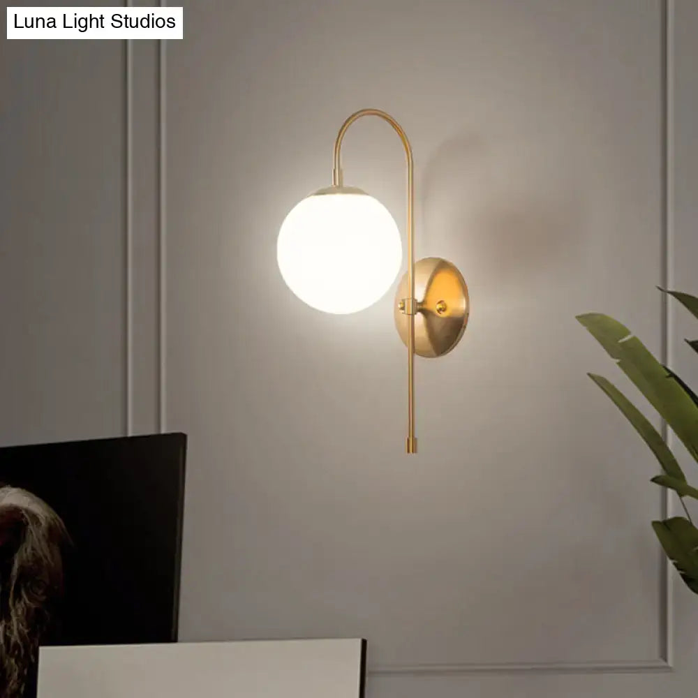 Gold Mini Globe Sconce by Decorbites with brass arc and white glass globe on Tampa Home & Garden Store