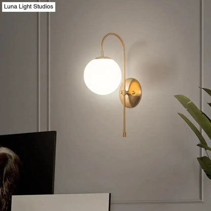 Gold Mini Globe Sconce by Decorbites with brass arc and white glass globe on Tampa Home & Garden Store