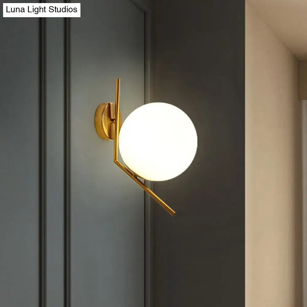 Gold Mini Globe Sconce with brass arms and white glass globe on Tampa Home & Garden Store