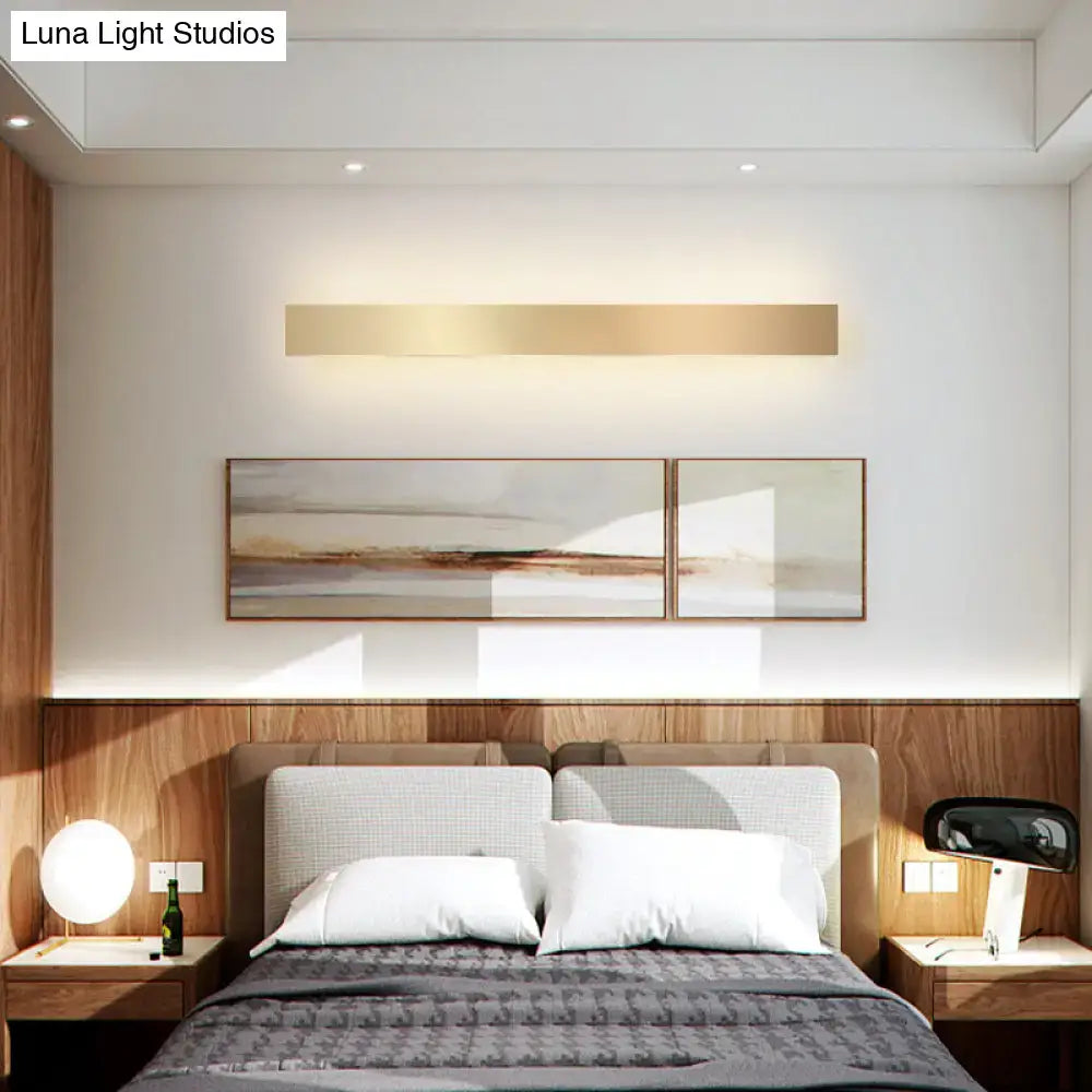 Minimalist gold plated LED wall sconce bar light over bed in modern bedroom decor on Tampa Home & Garden Store