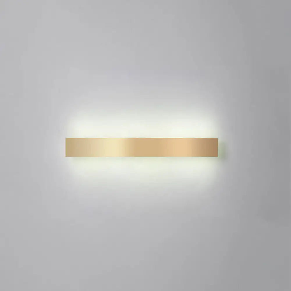 Minimalist gold plated LED wall sconce bar light by Decorbites with warm glow on wall on Tampa Home & Garden Store